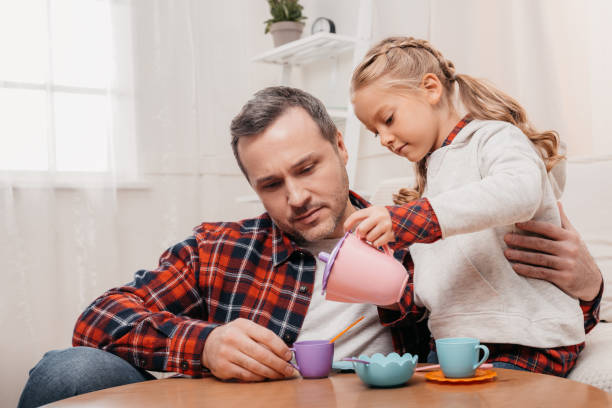 istock child having tea party with father 927096560