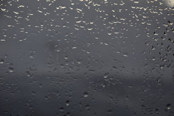 istock Rain drops on the window with sea background 927098726