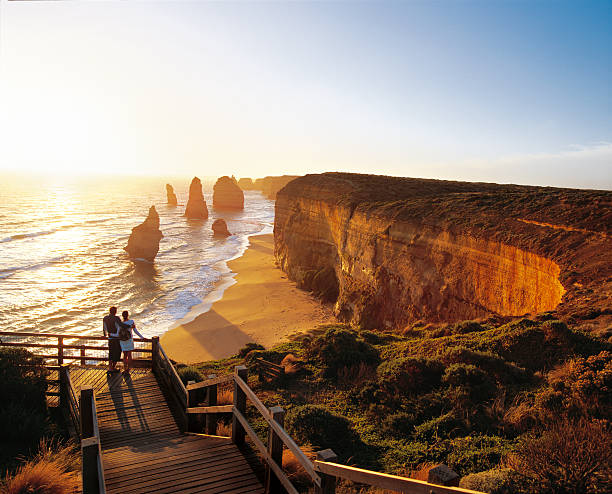 romantic sunset over the sea. - the twelve apostles stock-fotos und bilder