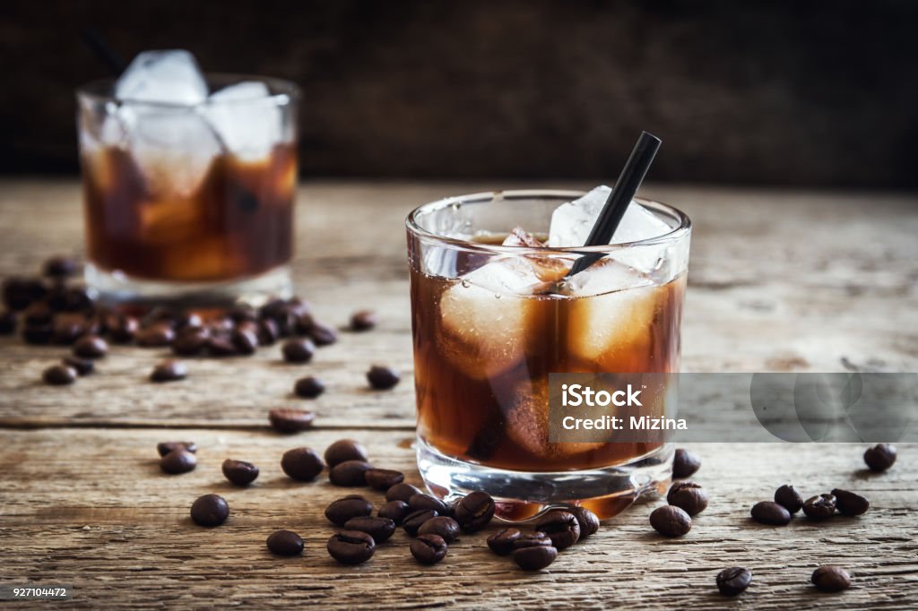 Black Russian Cocktail Black Russian Cocktail with Vodka and Coffee Liquor. Homemade Alcoholic Boozy Black Russian drink with coffee beans on wooden background with copy space. Coffee - Drink Stock Photo