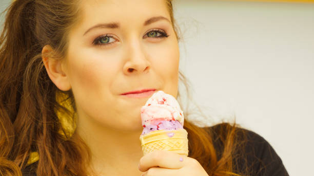istock Young woman eating ice cream 927108134