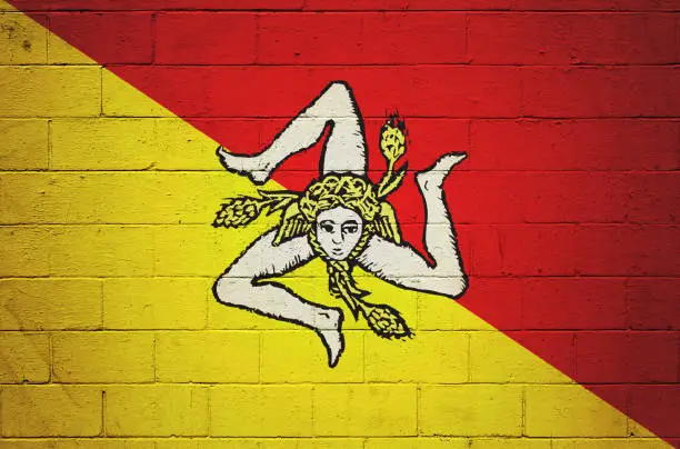 Flag of Sicilia painted on a brick wall.