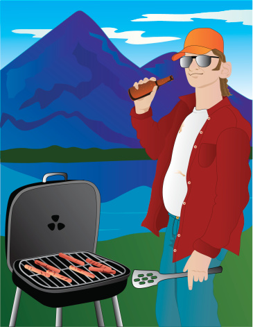 A good old boy grills hotdogs on a trip to the lake.  He's happy because he has beer.