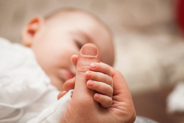 istock Father with his newborn baby care hands. 927121556
