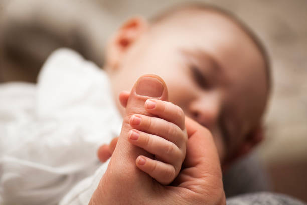 father with his newborn baby care hands. - newborn human hand baby father imagens e fotografias de stock