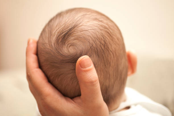 istock Father holding his newborn baby head. 927121568