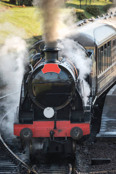 istock Beautiful old vintage steam railway engine with full steam blowing 927131784