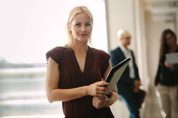 istock Confident business woman standing in office 927136060