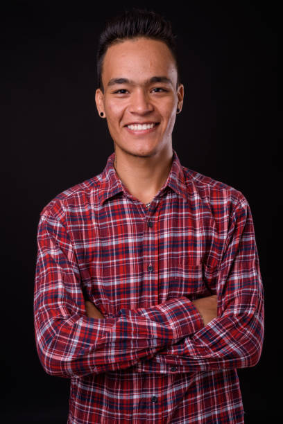 istock Young handsome Indian man against black background 927141924