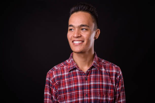 istock Young handsome Indian man against black background 927142042