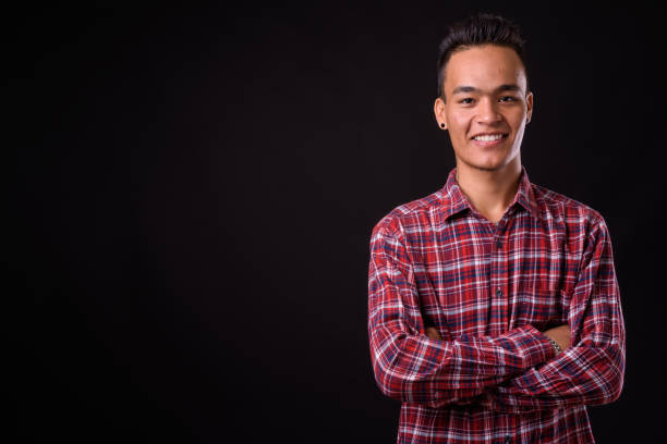istock Young handsome Indian man against black background 927142044