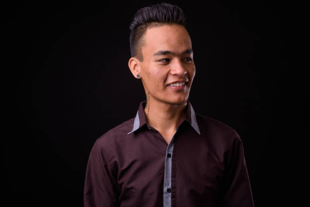 istock Young handsome Indian businessman against black background 927144532