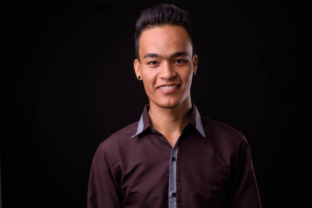istock Young handsome Indian businessman against black background 927144540