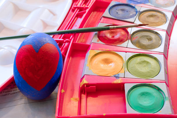 Painted Easter egg and colorful watercolors.