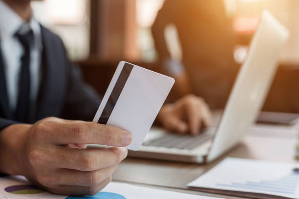 istock businessman holding credit card and using laptop computer. Online shopping concept 927156122