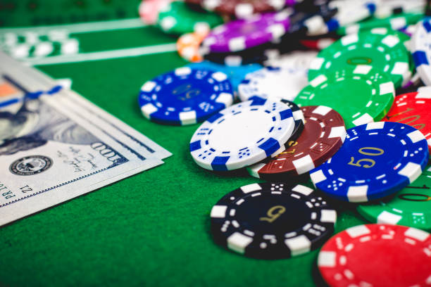 istock Poker chips and banknotes on table in casino 927156484