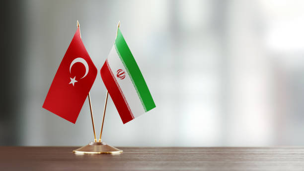istock Turkish And Iranian Flag Pair On A Desk Over Defocused Background 927165160