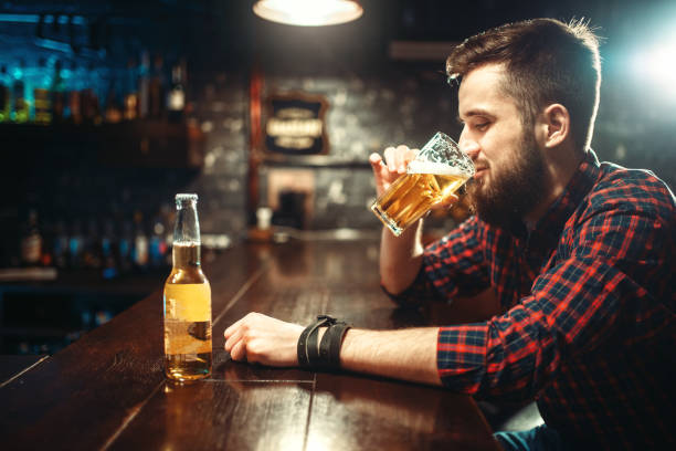 istock One bearded man drinks beer at the bar counter 927168974