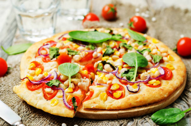 white beans, spinach, corn and tomato pizza with white beans crust white beans, spinach, corn and tomato pizza with white beans crust. toning. selective focus crostata photos stock pictures, royalty-free photos & images