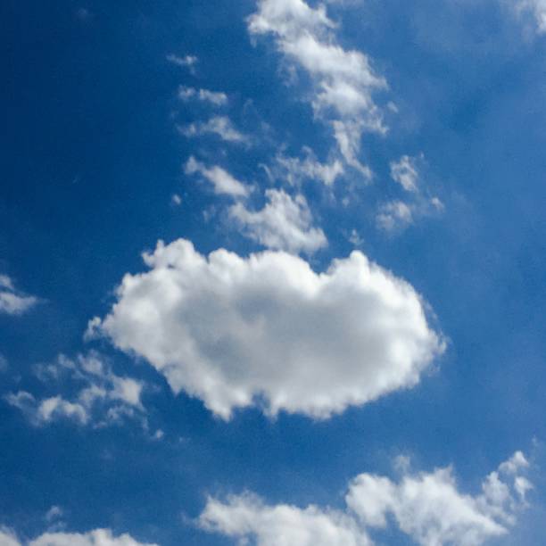istock Deep blue sunny sky with white clouds. Blue sky with cloud close-up. White fluffy clouds in the blue sky. 927173376