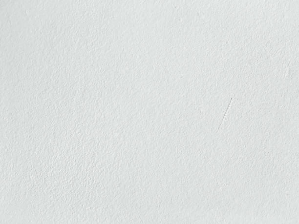 istock Grungy painted wall texture as background. Cracked concrete vintage wall background, old white painted wall. Background washed painting. 927178756