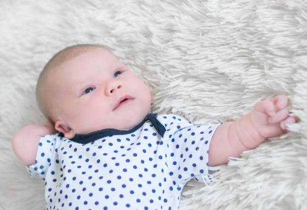 istock Newborn baby closeup thoughtfully lying on her back 927181840