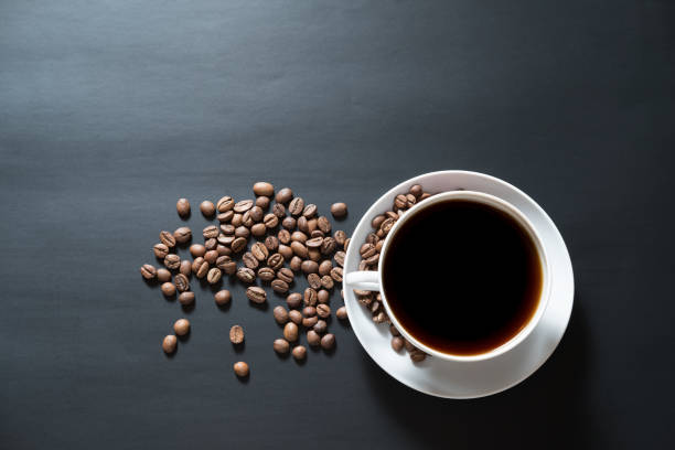 istock coffee is poured into a white cup with roasted coffee beans 927194516
