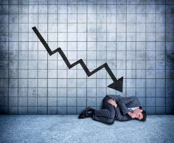 istock Businessman Curled Up In Fetal Position Distraught Over Falling Results 927195010