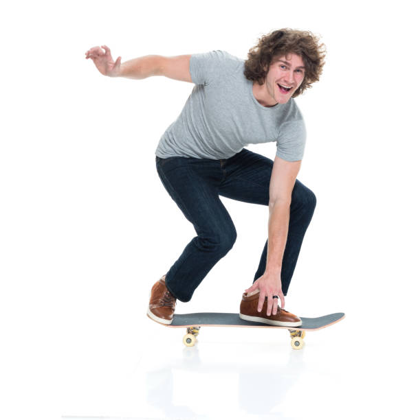 istock Handsome young male on skateboard and skating 927214074