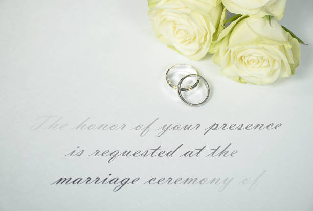 istock wedding rings and roses on invitation 927228608
