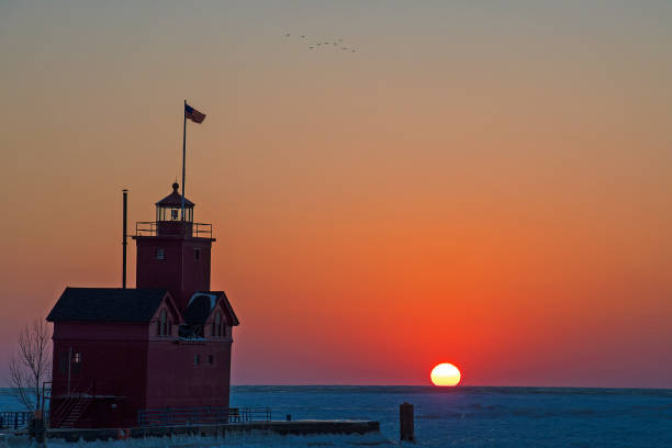 istock red Michigan lighthouse with winter sunset 927229020