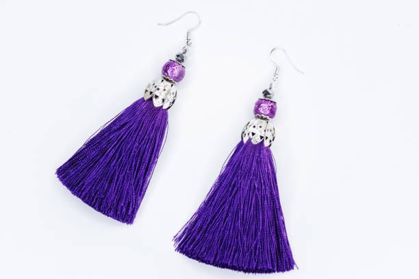 istock Purple handmade earrings on white 927229836