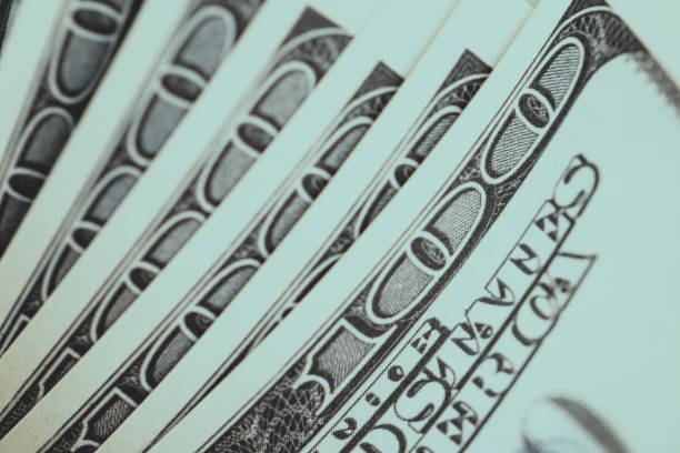 istock close-up 100 US dollar bills  background toned 927240610