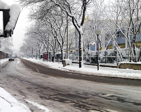 Snow and traffic in Evangile street in Paris France.