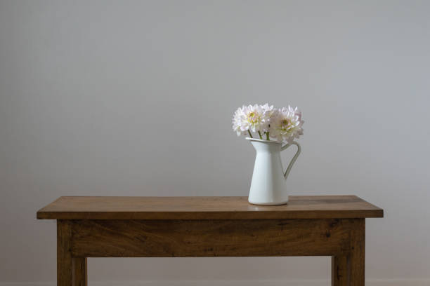 istock White dahlias in jug on wooden table 927250732