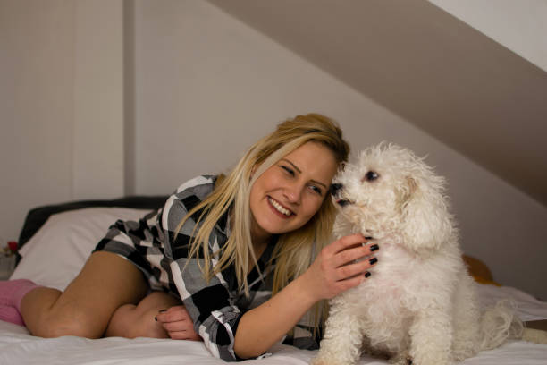 istock Enjoying at home with her dog in bed 927252810
