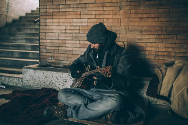 istock Man playing guitar in tunnel 927253006
