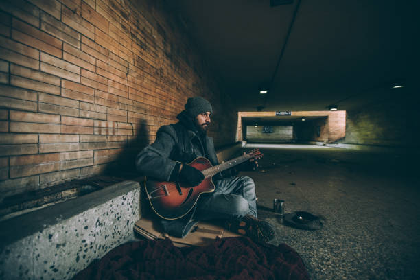 istock Man playing guitar outdoors 927253084