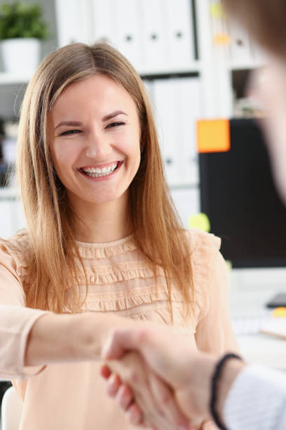 istock Businessman and woman shake hands as hello 927254742