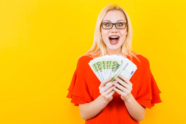 istock Blonde woman with cash 927256262