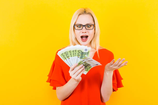 istock Blonde woman with cash 927256266