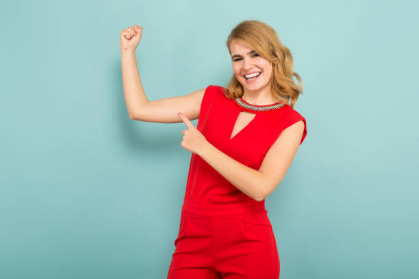 istock Attractive woman shows muscles 927256364