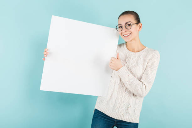 istock Attractive young woman with blank banner 927256692