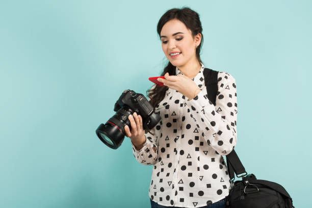 istock Young woman with camera and its case 927256748