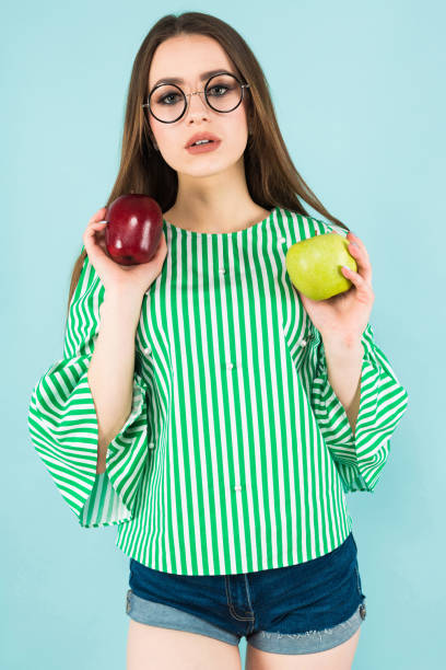 istock Young woman with two apples 927256934