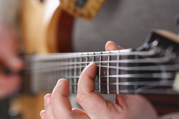 istock Male arms playing classic shape electric guitar 927258152