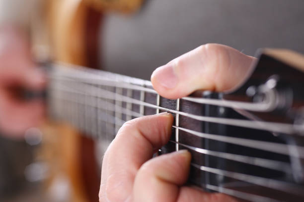 istock Male arms playing classic shape electric guitar 927258174