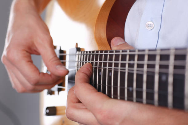 istock Male arms playing classic shape electric guitar 927258184