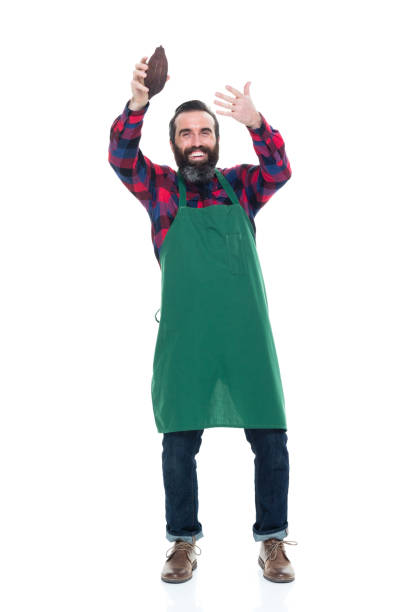istock Male artisan holding cocoa seed for chocolate making 927258592