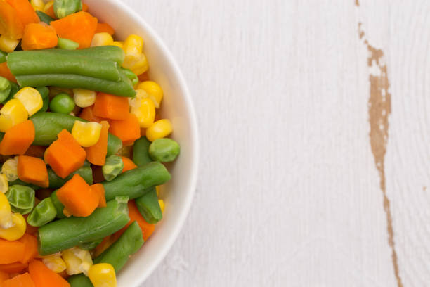 istock Steamed Mixed Vegetables Isolated on a White Wood Table 927262696